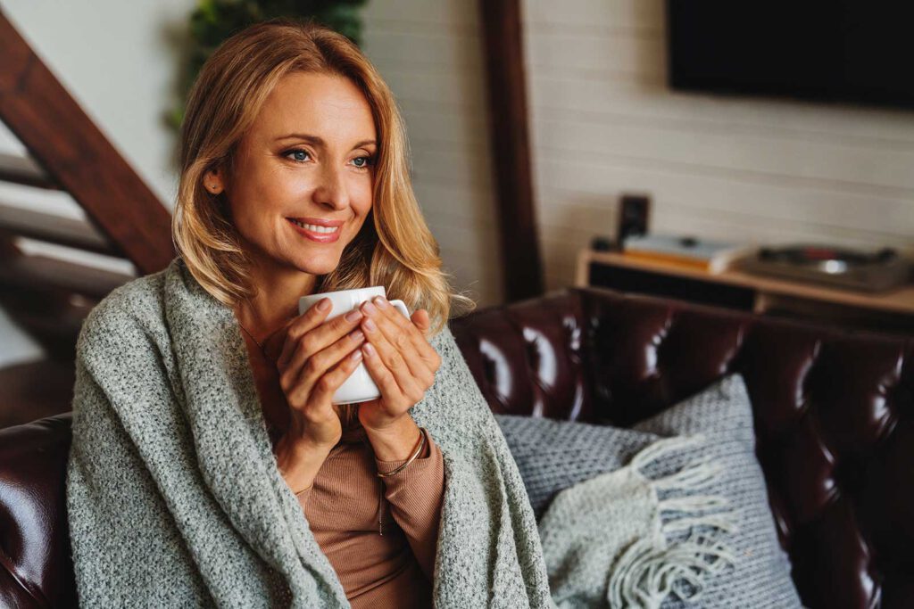 woman holding warm drink