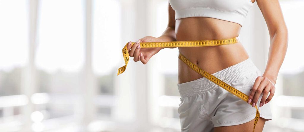 A woman steps on a scale